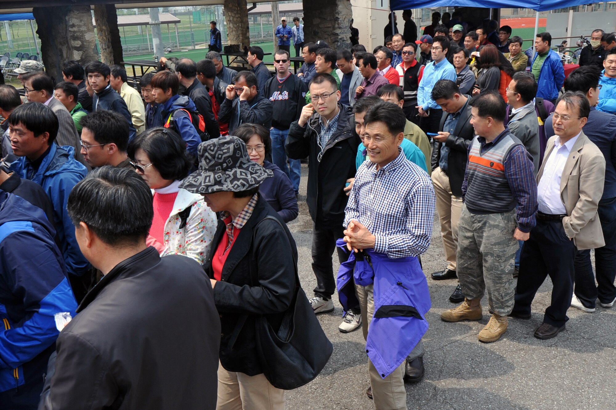 Korean union workers stand in line for lunch at that the 2013 Korean Union Labor Day cookout at Osan Air Base, Republic of Korea, May 3, 2013. Steak, rice, noodles and fruit were served at the cookout. (U.S. Air Force photo/Senior Airman Alexis Siekert)