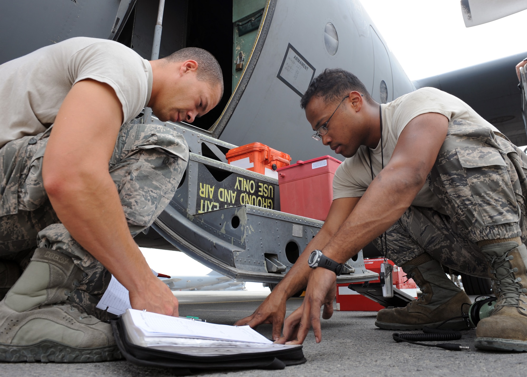 SOUTHWEST ASIA – Crew chiefs Staff Sgt. Bernard Warren and Senior Airman Marlin Kennedy review the aircraft forms prior to conducting post-flight maintenance, May 1. The 746th Expeditionary Aircraft Maintenance Unit crew chiefs support deployed C-130s which provide intra-theater combat airlift support throughout Southwest Asia. Warren is deployed from Pope Air Field, N.C. and Kennedy is deployed from Maxwell Air Force Base, Ala.(US. Air Force photo/Staff Sgt. Joel Mease)