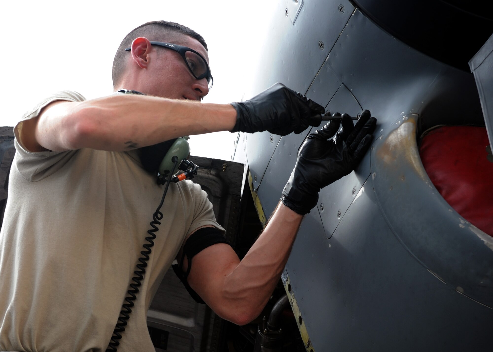 SOUTHWEST ASIA – Senior Airman Dave Smith, 746th Aircraft Maintenance Unit, opens an engine panel to do post-flight maintenance, May 1. Each C-130H turboprop is capable of delivering 4,591 prop shaft horsepower. Smith is deployed from Maxwell Air Force Base, Ala. (US. Air Force photo/Staff Sgt. Joel Mease)