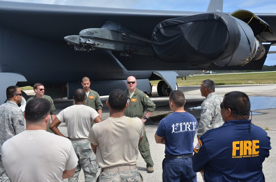 Capt. Chad Davis, 23rd Expeditionary Bomb Squadron instructor pilot, briefs 36th Civil Engineer Squadron Andersen Fire and Emergency Services members on safety procedures involving the B-52 Stratofortress on Andersen Air Force Base, Guam, April 30, 2013. The training covered various safety mishaps associated with the B-52 and allowed members from the 23rd EBS and the 36th CES to share best practices regarding aircraft safety. (U.S. Air Force photo by Staff Sgt. Veronica McMahon/Released)