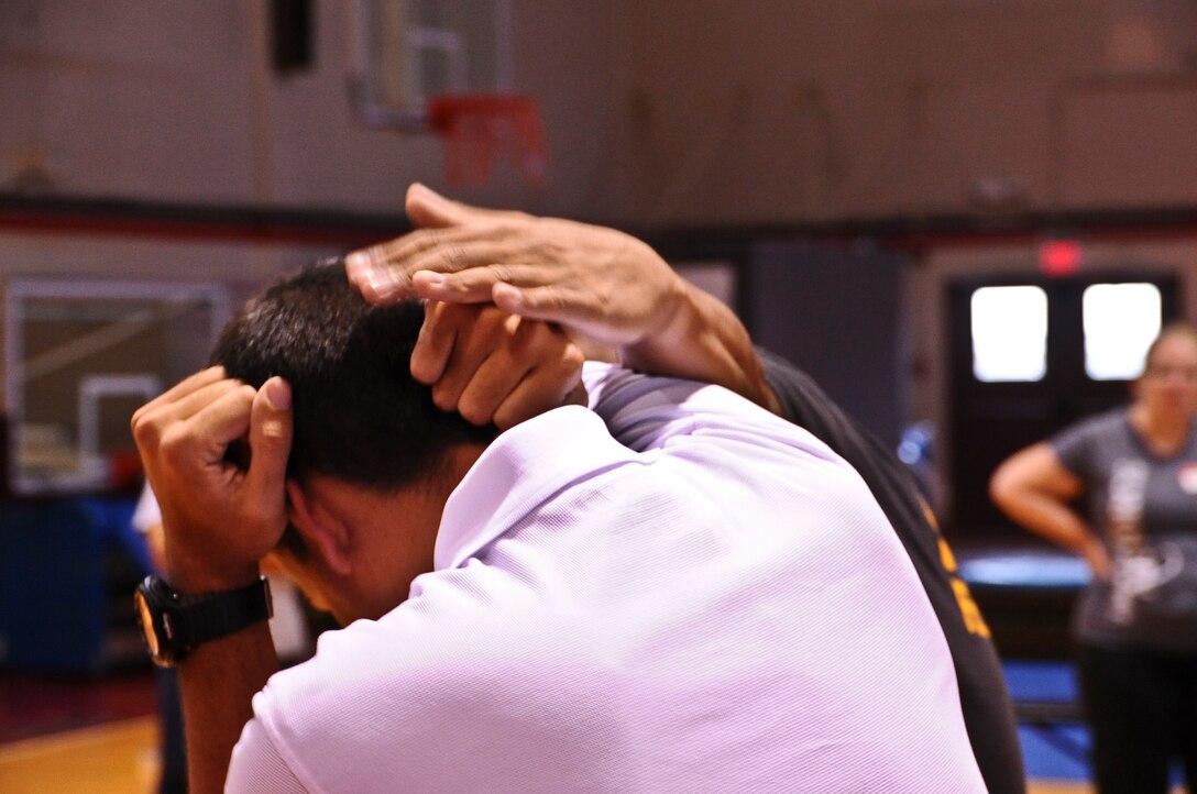 Special Agent Christopher Kervin, Air Force Office of Special Investigations, Detachment 602 demonstrates how to defend against an attacker during a self-defense class at the Hot spot gym on Andersen Air Force, Guam, April 30, 2013. This was one of several events held in the month of April as part of Sexual Assault Awareness Month. (U.S. Air Force photo by Airman 1st Class Adarius Petty/Released)