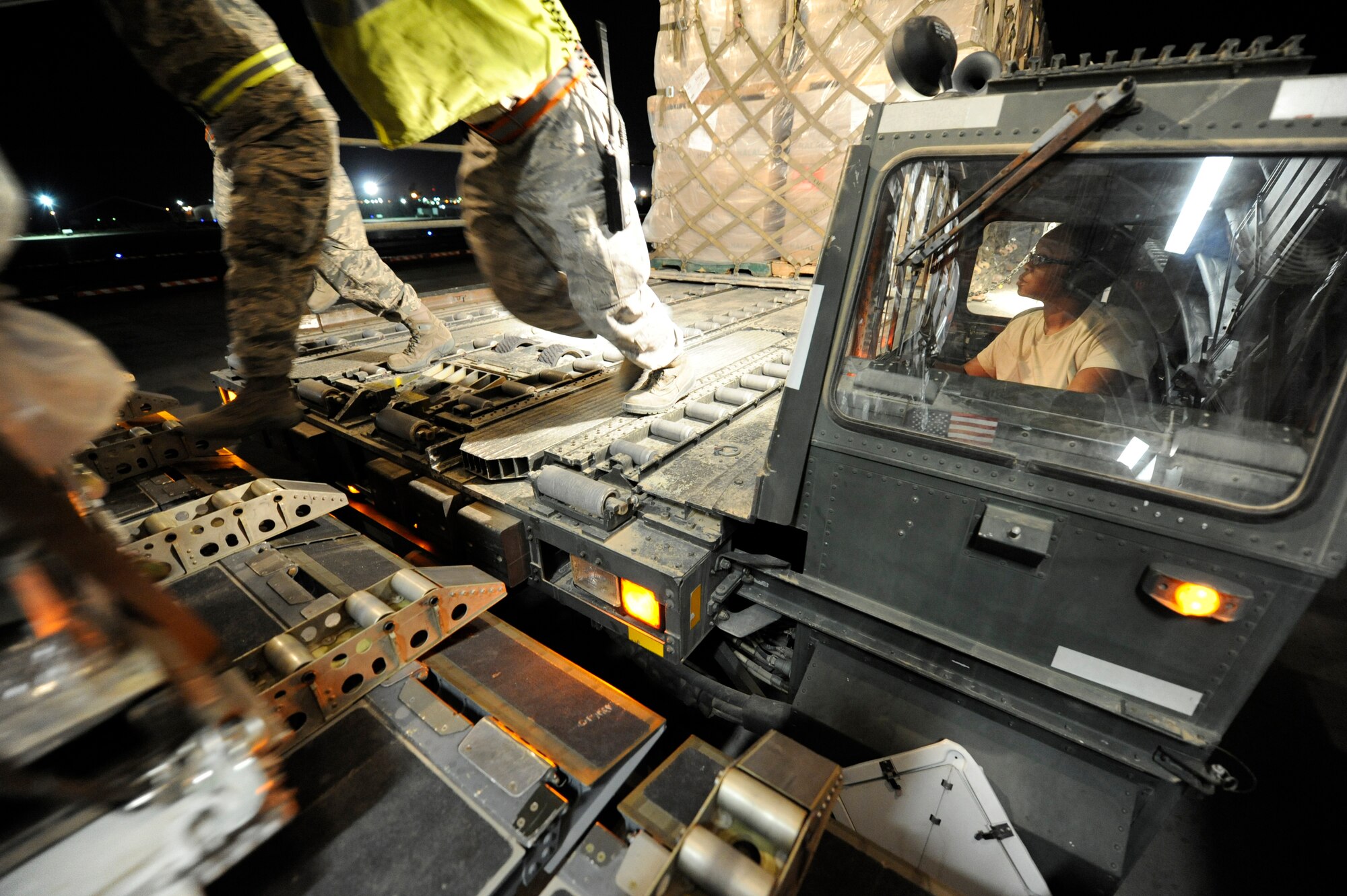 Airman from the 386th Expeditionary Logistics Readiness Squadron and Air Mobility Command work together to load pallets of non-lethal aid on to a C-17 aircraft at an undisclosed base in Southwest Asia Apr 30, 2013. (U.S. Air Force photo/Staff Sgt. Austin Knox)