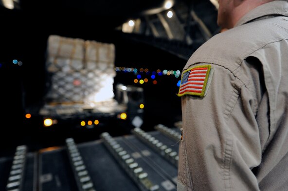 Airman from the 386th Expeditionary Logistics Readiness Squadron and Air Mobility Command work together to load pallets of non-lethal aid on to a C-17 aircraft at an undisclosed base in Southwest Asia Apr 30, 2013. (U.S. Air Force photo/Staff Sgt. Austin Knox)