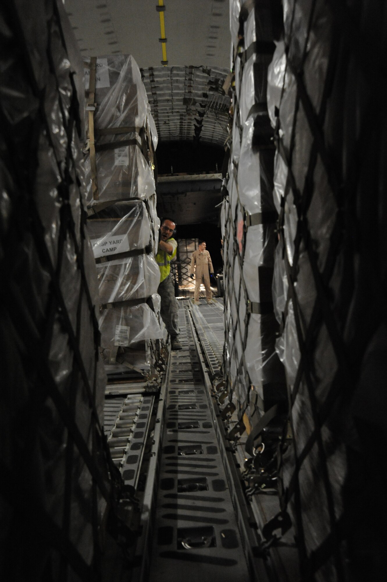 Airman from the 386th Expeditionary Logistics Readiness Squadron and Air Mobility Command work together to load pallets of non-lethal aid on to a C-17 aircraft at an undisclosed base in Southwest Asia Apr 30, 2013. (U.S. Air Force photo/Senior Master Sgt. George Thompson)