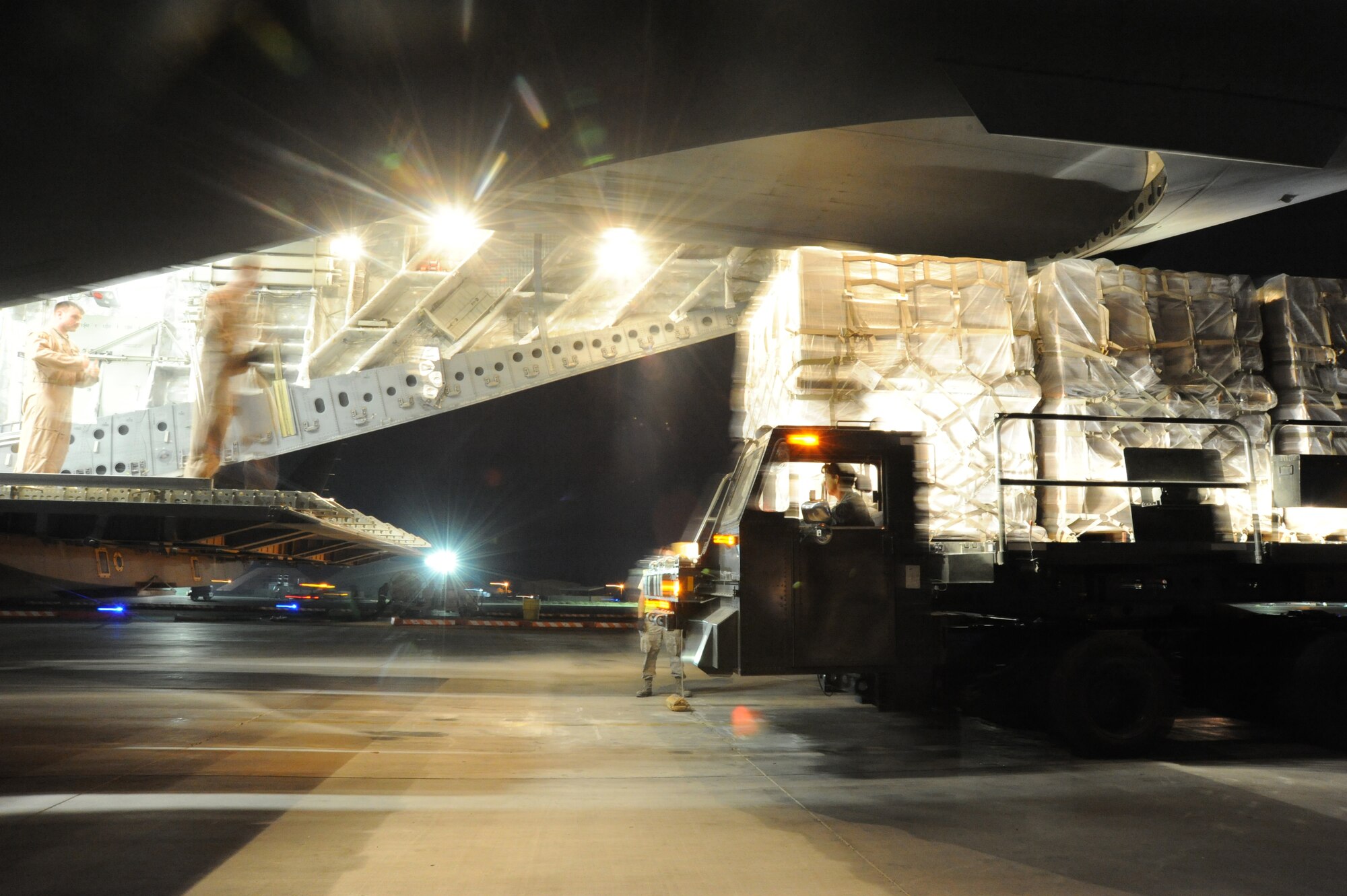 Airman from the 386th Expeditionary Logistics Readiness Squadron and Air Mobility Command work together to load pallets of non-lethal aid on to a C-17 aircraft at an undisclosed base in Southwest Asia Apr 30, 2013. (U.S. Air Force photo/Senior Master Sgt. George Thompson)
