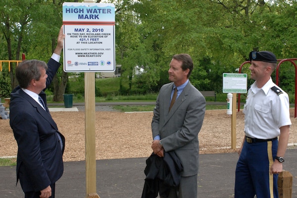 (Left to right) Nashville Mayor Karl Dean; Scott Potter, director of Metro Water Services; and Lt. Col. James A. DeLapp, U.S. Army Corps of Engineers Nashville District commander, unveil the first of more than a dozen high water marks to be placed in the city as part of the "Know Your Line: Be Flood Aware" Initiative.  The event took place at England Park May 2, 2013.