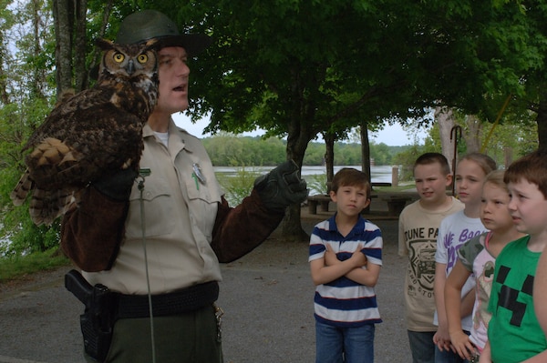 Montgomery Bell State Park Ranger Tim Wheatley shows and tells about the Great Horned Owl during the Cheatham Lake Environmental Awareness Day May 2, 2013 at Cheatham Lake in Ashland City, Tenn. The U.S. Army Corps of Engineers Nashville District organized the event where students from West Cheatham Elementary School learned about various environmental topics in an outdoors setting.
