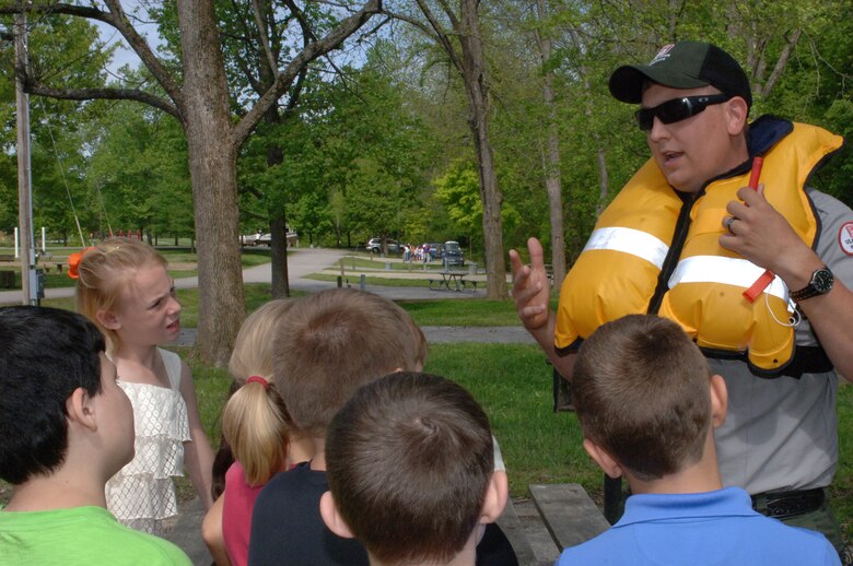 Park Ranger Dean Austin, U.S. Army Corps of Engineers Nashville District, demonstrates the use of an inflatable personal flotation device to West Cheatham Elementary School Students May 3, 2013 on Environmental Awareness Day at Ashland City, Tenn. He explained that they are only for adult use but suggested they share the information with their parents. 