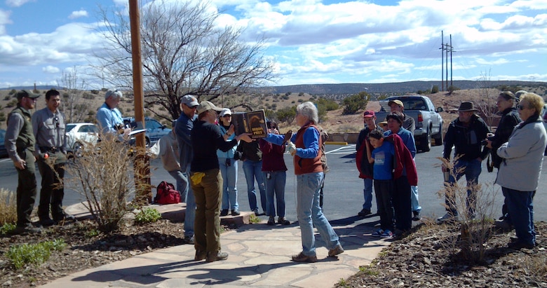 ABIQUIU LAKE, N.M., -- Katherine Eagleson, director of the Espanola Wildlife Center, shares about the kestrel to volunteers at Abiquiu Lake's Earth Day event, April 20, 2013.