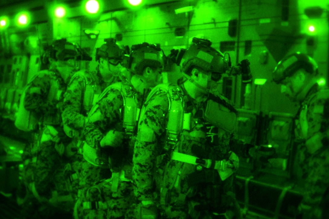As seen through a night-vision device, a Canadian special operations forces service member checks equipment before a high altitude jump from a C-17 Globemaster III aircraft during Emerald Warrior 2013 over Hurlburt Field, Fla., April 29, 2013.