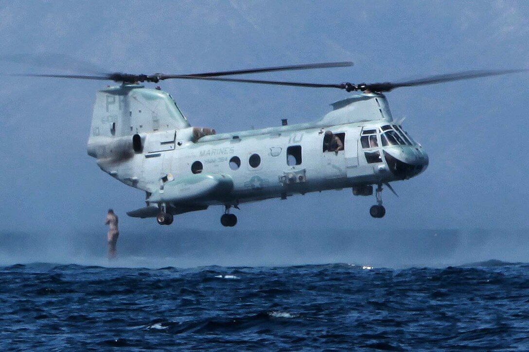 A CH-46 Sea Knight helicopter with HMM 364 (Rein.), 15th Marine Expeditionary Unit, hovers above the water as Marines with Kilo Company, Battalion Landing Team 3/5, 15th MEU, conduct helo casting exercises at Arta Beach, Djibouti, Feb. 11. The helicopter was conducting exercises as part of sustainment training during the MUE’s Western Pacific Deployment 12-02. The 15th MEU is deployed as part of the USS Peleliu Group, and is scheduled to complete its eight-month deployment and return to Marine Corps Air Station Camp Pendleton Sept. 13. (U.S. Marine Corps photo by Cpl. John Robbart III/Released)