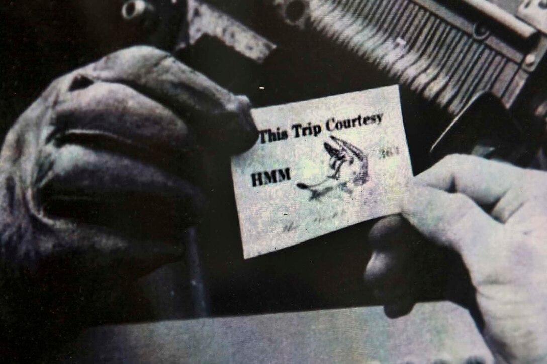 A pilot with HMM-364’s Purple Foxes, hands a calling card to a troop in this undated photo. The pilots gave these calling cards out to troops as they were picked up and transported from one location to another. Marine Medium Helicopter 364 (Rein) squadron is the aviation combat element for the 15th Marine Expeditionary Unit and is scheduled to complete its eight-month deployment and return to Marine Corps Air Station Camp Pendleton Sept. 13.