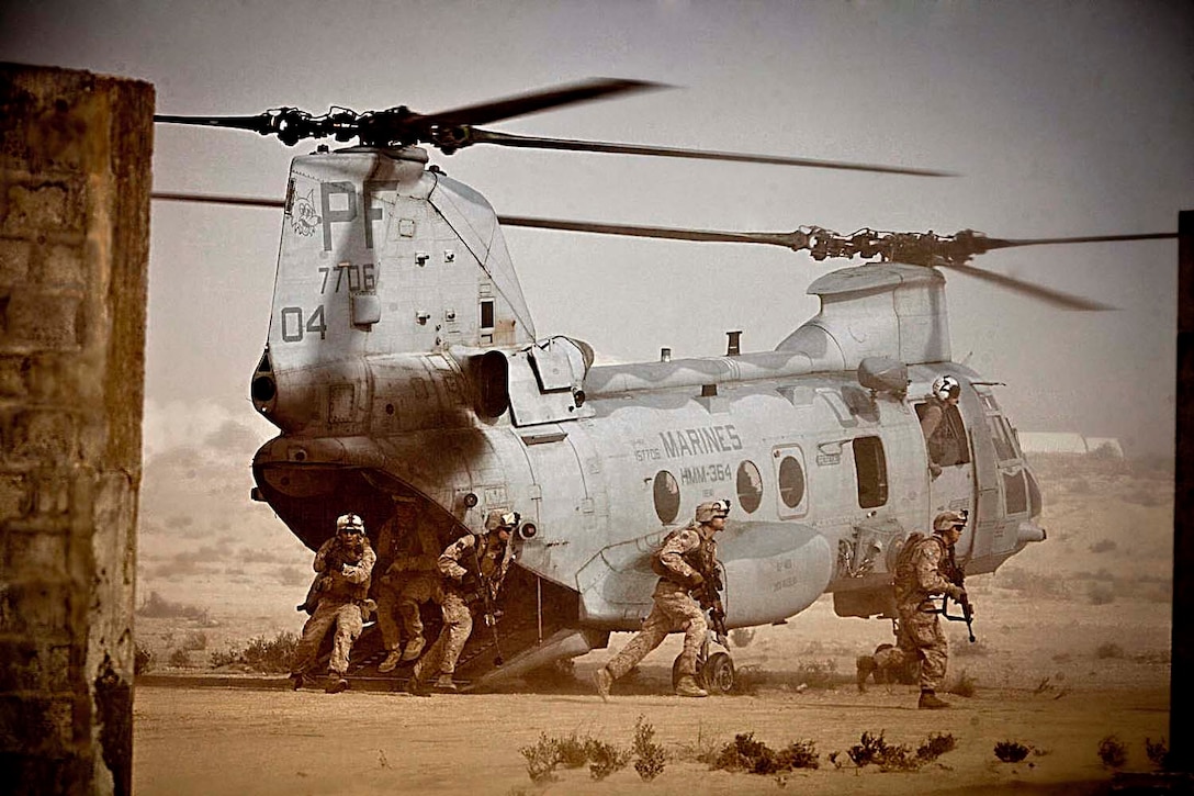 Marines with Lima Company, Battalion Landing Team 3/5, 15th Marine Expeditionary Unit (MEU), exit a CH-46E Sea Knight during Exercise Red Reef 13, in the Kingdom of Saudi Arabia, Jan. 7, 2013. Red Reef is a bilateral amphibious exercise between the 15th MEU and Saudi forces that focuses on expanding levels of cooperation, enhancing mutual maritime capabilities, as well as promoting long-term regional stability and interoperability between U.S. forces and the Kingdom of Saudi Arabia. The 15th MEU is deployed as part of the USS Peleliu Group, and is scheduled to complete its eight-month deployment and return to Marine Corps Air Station Camp Pendleton Sept. 13. (U.S. Marine Corps photo by Cpl. Bobby J. Gonzalez/Released)