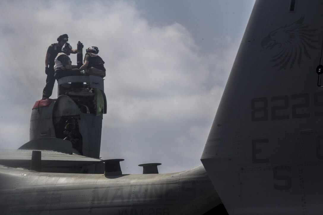 U.S. Marines with Medium Tiltrotor Squadron 266 (Reinforced), 26th Marine Expeditionary Unit (MEU) conduct maintenance on a MV-22 Osprey on the flight deck of the USS Kearsarge (LHD 3), at sea, May 4, 2013. The 26th MEU is deployed to the 5th Fleet area of operations aboard the Kearsarge Amphibious Ready Group. The 26th MEU operates continuously across the globe, providing the president and unified combatant commanders with a forward-deployed, sea-based quick reaction force. The MEU is a Marine Air-Ground Task Force capable of conducting amphibious operations, crisis response and limited contingency operations. (U.S. Marine Corps photograph by Gunnery Sgt. Michael Kropiewnicki/26th MEU Combat Camera/Released)