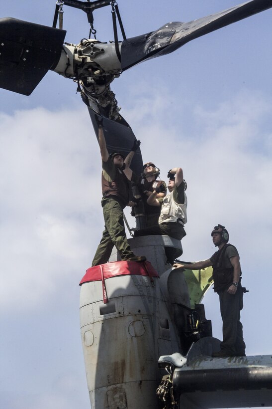 U.S. Marines with Medium Tiltrotor Squadron 266 (Reinforced), 26th Marine Expeditionary Unit (MEU) prepare to mount a rotor of an MV-22 Osprey on the flight deck of the USS Kearsarge (LHD 3), at sea, May 4, 2013. The 26th MEU is deployed to the 5th Fleet area of operations aboard the Kearsarge Amphibious Ready Group. The 26th MEU operates continuously across the globe, providing the president and unified combatant commanders with a forward-deployed, sea-based quick reaction force. The MEU is a Marine Air-Ground Task Force capable of conducting amphibious operations, crisis response and limited contingency operations. (U.S. Marine Corps photograph by Gunnery Sgt. Michael Kropiewnicki/26th MEU Combat Camera/Released)
