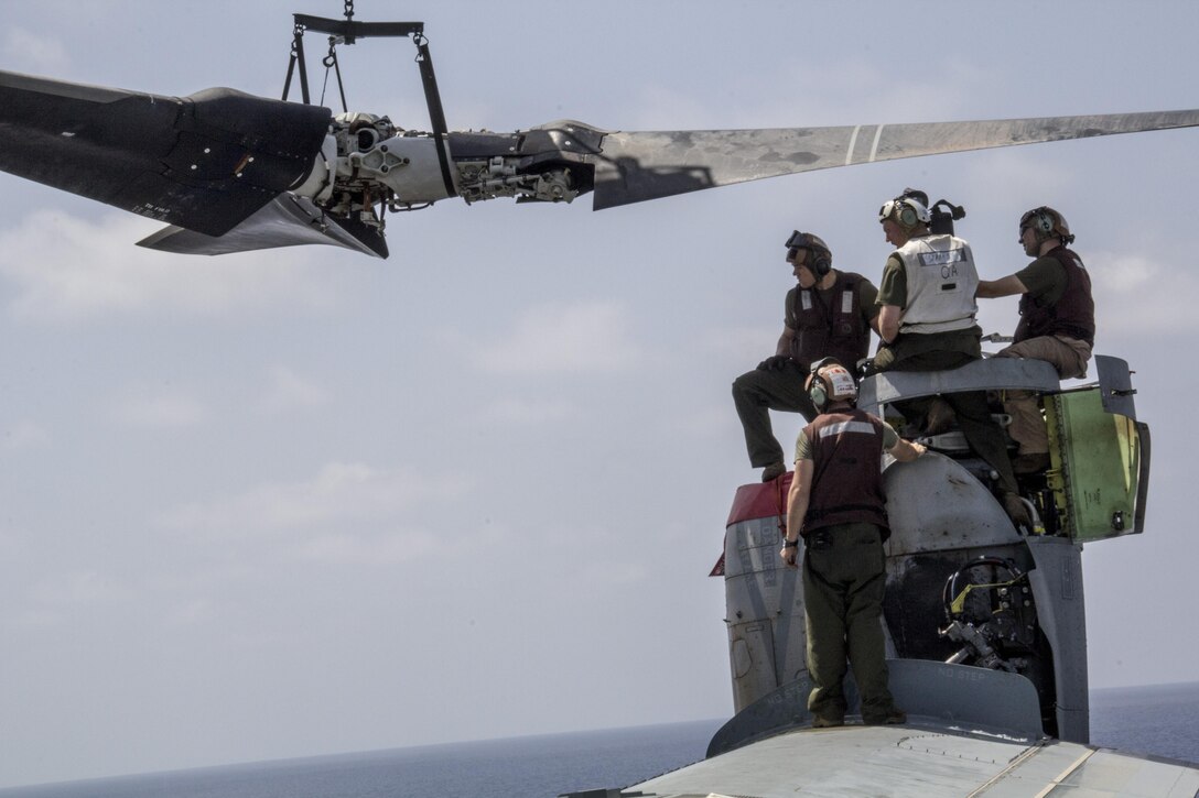 U.S. Marines with Medium Tiltrotor Squadron 266 (Reinforced), 26th Marine Expeditionary Unit (MEU) prepare to mount a rotor of an MV-22 Osprey on the flight deck of the USS Kearsarge (LHD 3), at sea, May 4, 2013. The 26th MEU is deployed to the 5th Fleet area of operations aboard the Kearsarge Amphibious Ready Group. The 26th MEU operates continuously across the globe, providing the president and unified combatant commanders with a forward-deployed, sea-based quick reaction force. The MEU is a Marine Air-Ground Task Force capable of conducting amphibious operations, crisis response and limited contingency operations. (U.S. Marine Corps photograph by Gunnery Sgt. Michael Kropiewnicki/26th MEU Combat Camera/Released)