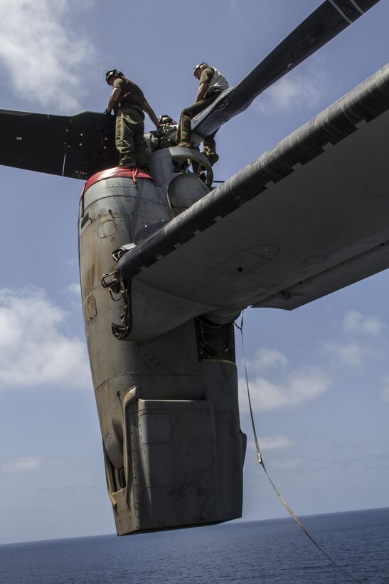 U.S. Marines with Medium Tiltrotor Squadron 266 (Reinforced), 26th Marine Expeditionary Unit (MEU) conduct maintenance on a MV-22 Osprey on the flight deck of the USS Kearsarge (LHD 3), at sea, May 4, 2013. The 26th MEU is deployed to the 5th Fleet area of operations aboard the Kearsarge Amphibious Ready Group. The 26th MEU operates continuously across the globe, providing the president and unified combatant commanders with a forward-deployed, sea-based quick reaction force. The MEU is a Marine Air-Ground Task Force capable of conducting amphibious operations, crisis response and limited contingency operations. (U.S. Marine Corps photograph by Gunnery Sgt. Michael Kropiewnicki/26th MEU Combat Camera/Released)