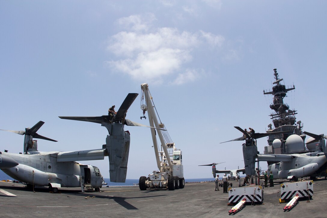 U.S. Marines with Medium Tiltrotor Squadron 266 (Reinforced), 26th Marine Expeditionary Unit (MEU), and Sailors assigned to the USS Kearsarge (LHD 3) move a rotor for an MV-22 Osprey on the flight deck of the USS Kearsarge, at sea, May 4, 2013. The 26th MEU is deployed to the 5th Fleet area of operations aboard the Kearsarge Amphibious Ready Group. The 26th MEU operates continuously across the globe, providing the president and unified combatant commanders with a forward-deployed, sea-based quick reaction force. The MEU is a Marine Air-Ground Task Force capable of conducting amphibious operations, crisis response and limited contingency operations. (U.S. Marine Corps photograph by Cpl. Kyle N. Runnels/Released)