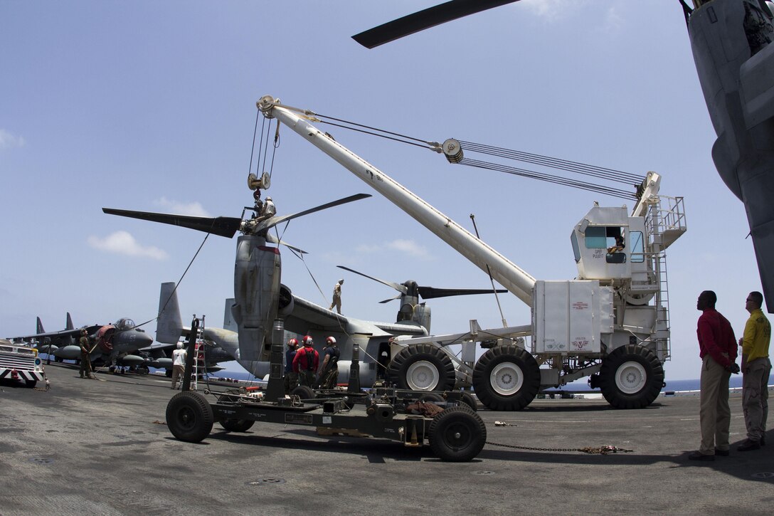 U.S. Marines with Medium Tiltrotor Squadron 266 (Reinforced), 26th Marine Expeditionary Unit (MEU), and Sailors assigned to the USS Kearsarge (LHD 3) move a rotor for an MV-22 Osprey on the flight deck of the USS Kearsarge, at sea, May 4, 2013. The 26th MEU is deployed to the 5th Fleet area of operations aboard the Kearsarge Amphibious Ready Group. The 26th MEU operates continuously across the globe, providing the president and unified combatant commanders with a forward-deployed, sea-based quick reaction force. The MEU is a Marine Air-Ground Task Force capable of conducting amphibious operations, crisis response and limited contingency operations. (U.S. Marine Corps photograph by Cpl. Kyle N. Runnels/Released)