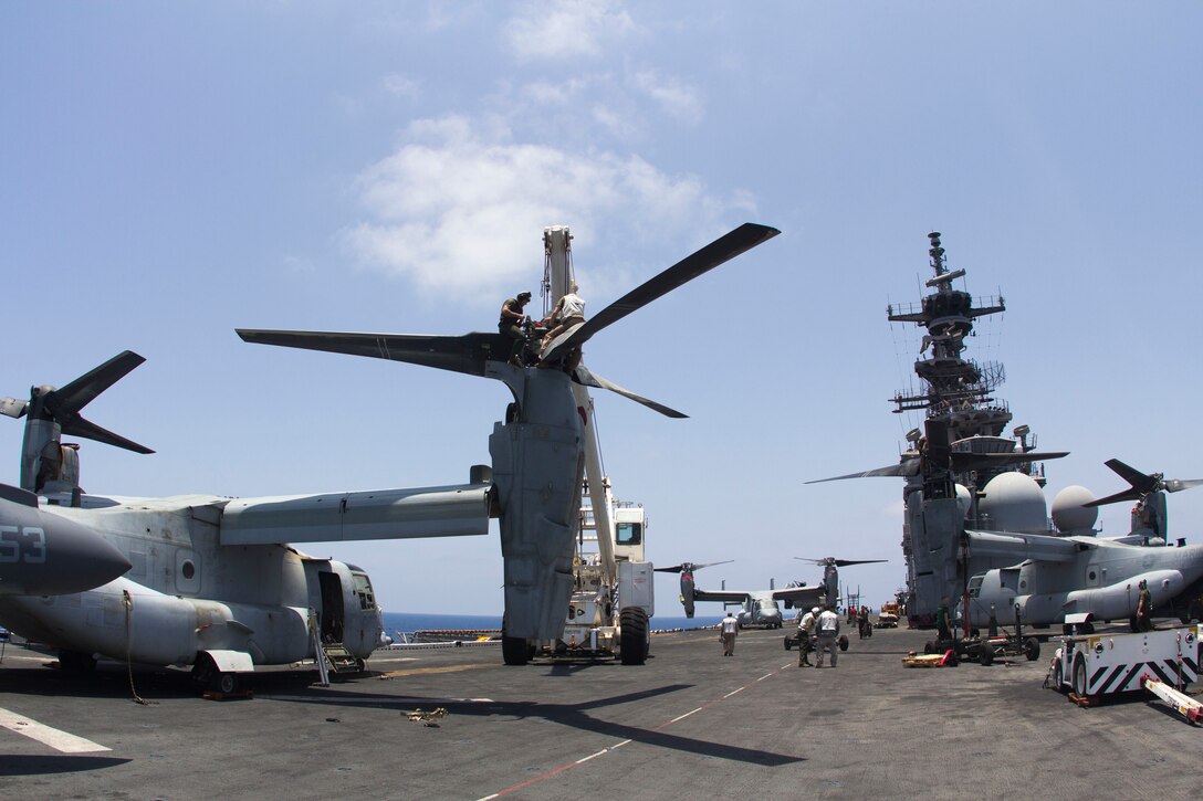 U.S. Marines with Medium Tiltrotor Squadron 266 (Reinforced), 26th Marine Expeditionary Unit (MEU), and Sailors assigned to the USS Kearsarge (LHD 3) move a rotor for an MV-22 Osprey on the flight deck of the USS Kearsarge, at sea, May 4, 2013. The 26th MEU is deployed to the 5th Fleet area of operations aboard the Kearsarge Amphibious Ready Group. The 26th MEU operates continuously across the globe, providing the president and unified combatant commanders with a forward-deployed, sea-based quick reaction force. The MEU is a Marine Air-Ground Task Force capable of conducting amphibious operations, crisis response and limited contingency operations. (U.S. Marine Corps photograph by Cpl. Kyle N. Runnels/Released)