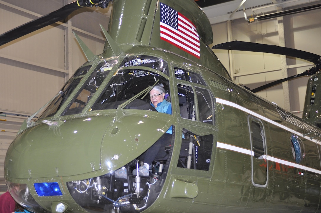 Debra Rapisarda, MV-22B Introduction Ceremony attendee, sits in the cockpit of a CH-46E presidential support helicopter prior to the ceremony in the HMX-1 hangar on May 4, 2013. Rapisarda is the sister-in-law of David Lee who flew in Marine One as part of the security detail for former Presidents Richard Nixon and Gerald Ford.