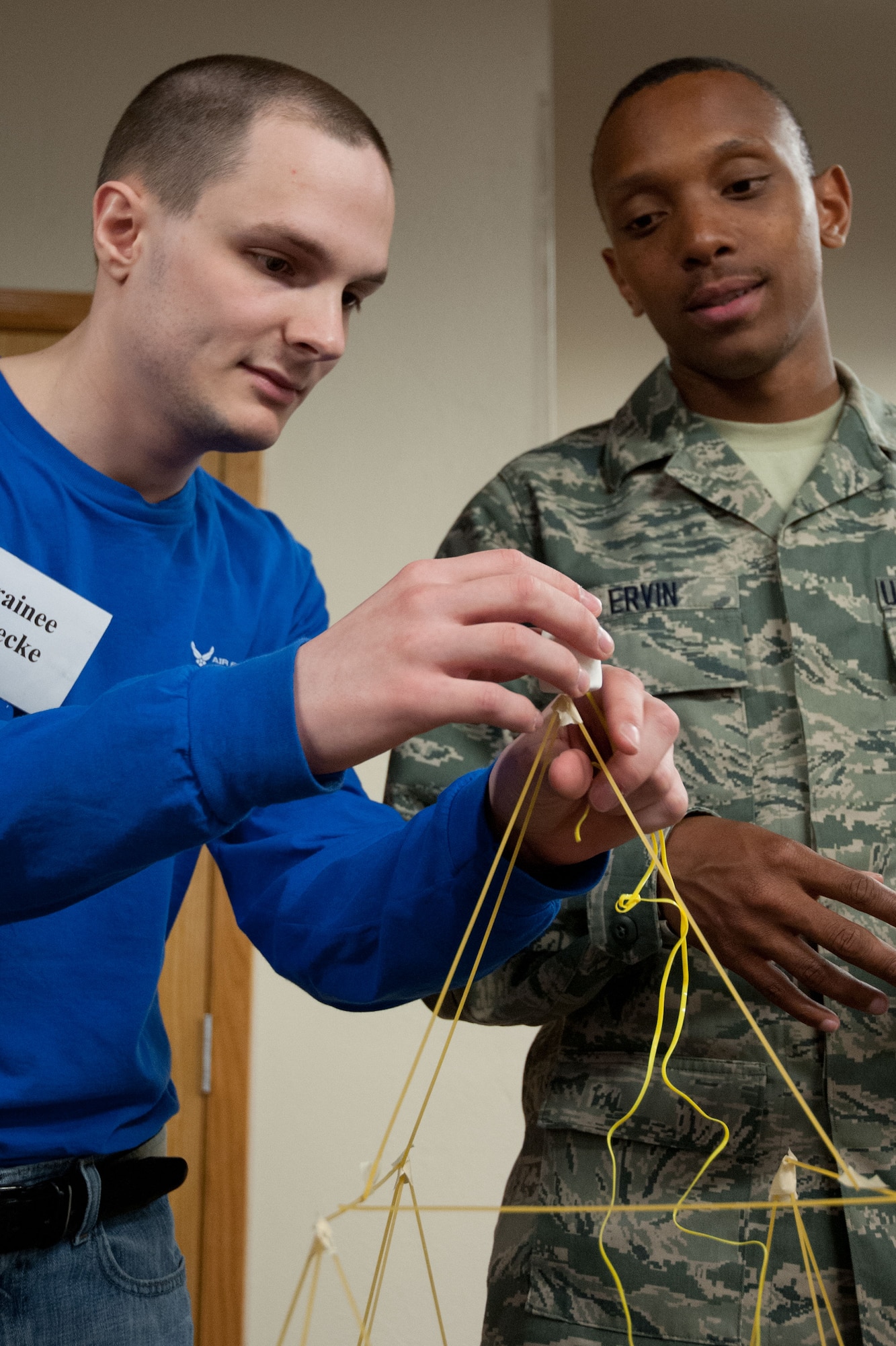 Trainee Kyle Muecke and Airman Trent Ervin, 934th Logistics Readiness Squadron, work together to create the tallest free standing structure able to hold a marshmallow.  Members of the 934th Airlift Wing Development Training Flight competed in a marshmallow challenge on May 5, at the Minneapolis-St. Paul Air Reserve Station, Minn.  The challenge was to build the tallest free standing structure strong enough to hold a marshmallow and tested trainees on problem solving, making assumptions, and teamwork.  (US Air Force Photo/Staff Sgt. Samantha Wagner)