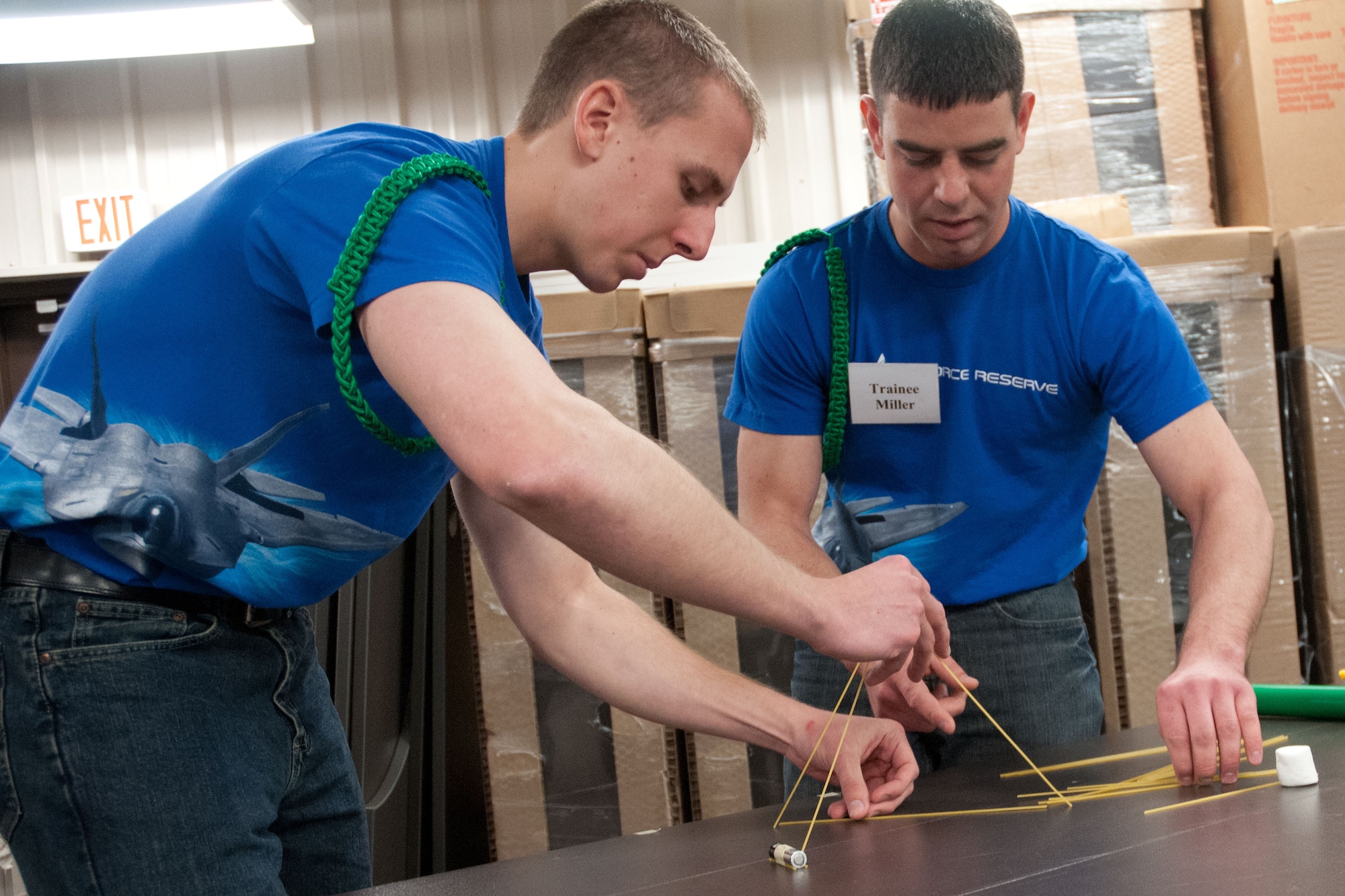 Trainees Tony Loeks and Blaine Miller work together to build a structure strong enough to hold a marshmallow.  Members of the 934th Airlift Wing Development Training Flight competed in a marshmallow challenge on May 5, at the Minneapolis-St. Paul Air Reserve Station, Minn.  The challenge was to build the tallest free standing structure strong enough to hold a marshmallow and tested trainees on problem solving, making assumptions, and teamwork.  (US Air Force Photo/Staff Sgt. Samantha Wagner)
