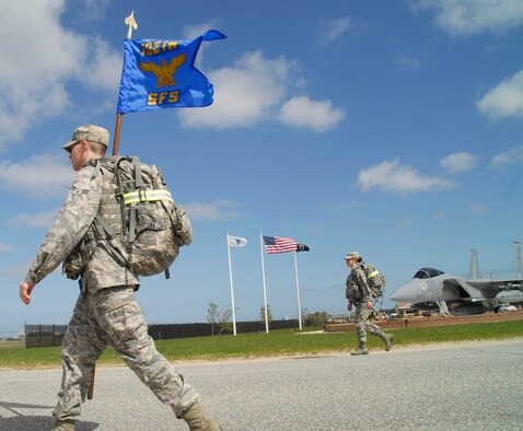More than 30 members of the 102nd Security Forces Squadron took part in a ruck march around Otis Air National Guard Base, Mass.  May 4, 2013. The approximately four mile march took the place of the squadron’s usual physical training session and required each 102 SFS defender to carry more than 30 pounds of gear on their back. Staff Sgt. Gary Bent, 102 SFS, who recently finished first in the ruck march race at the Massachusetts National Guard Best Warrior Competition, planned the march’s route and format. (U.S. Air National Guard photo by Senior Airman Patrick McKenna)