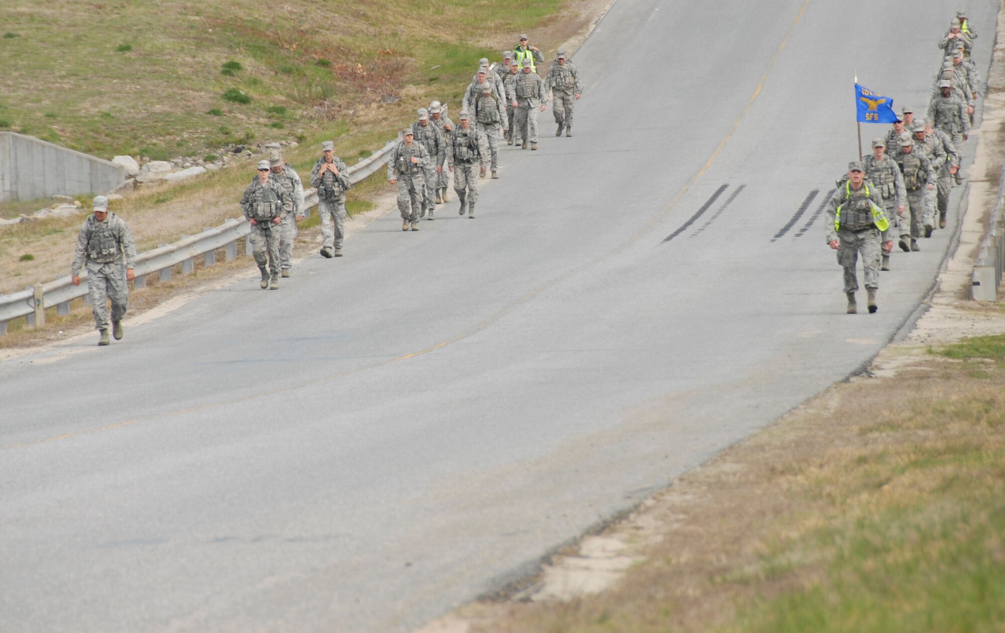 More than 30 members of the 102nd Security Forces Squadron took part in a ruck march around Otis Air National Guard Base, Mass.  May 4, 2013. The approximately four mile march took the place of the squadron’s usual physical training session and required each 102 SFS defender to carry more than 30 pounds of gear on their back. Staff Sgt. Gary Bent, 102 SFS, who recently finished first in the ruck march race at the Massachusetts National Guard Best Warrior Competition, planned the march’s route and format. (U.S. Air National Guard photo by Senior Airman Patrick McKenna)