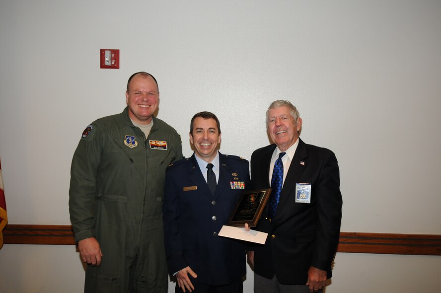 U.S. Air Force Col. Gary Brewer, 161st Air Refueling Wing commander; and Al Shipley, Tempe Military Affairs Committee chair; present Lt. Col. John Conley, 161 ARW judge advocate general, with the Maj. Truman Young award during a ceremony March 21, 2013. Formed more than 30 years ago to honor military members of Arizona Guard and Reserve units, the Tempe Military Affairs Committee conducts luncheons to present awards to outstanding officer and enlisted personnel. The 161 ARW award was named for Maj. Truman Young who lost his life when his KC-135 crashed in March 1982. (U.S. Air National Guard photo by Master Sgt. Kelly Deitloff/Released)