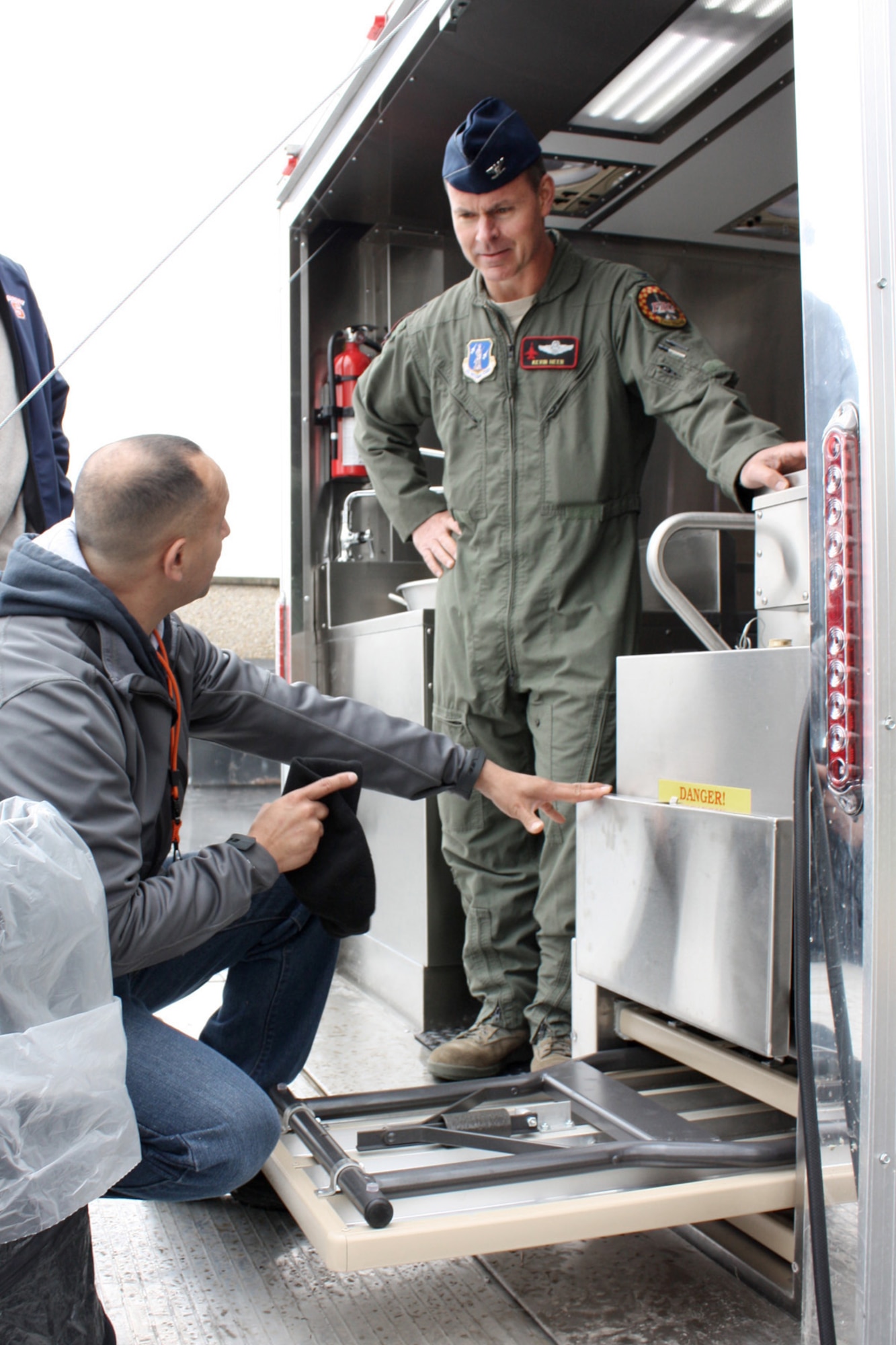 Ramiro "Junior" Andrade (left), Product Manager with Babington Technologies, explains the inner workings of the Disaster Relief Mobile Kitchen Trailer (DRMKT) to Col. Kevin Heer (right), Vice Commander of the 132nd Fighter Wing (132FW), Des Moines, Iowa, outside of the Dining Facility at the 132FW on May 4, 2013.  This DRMKT is one of 5 in the world, and will be used to feed those in need after disasters such as floods and tornadoes.  (U.S. Air National Guard photo by Tech. Sgt. Sara M. Robinson/Released)