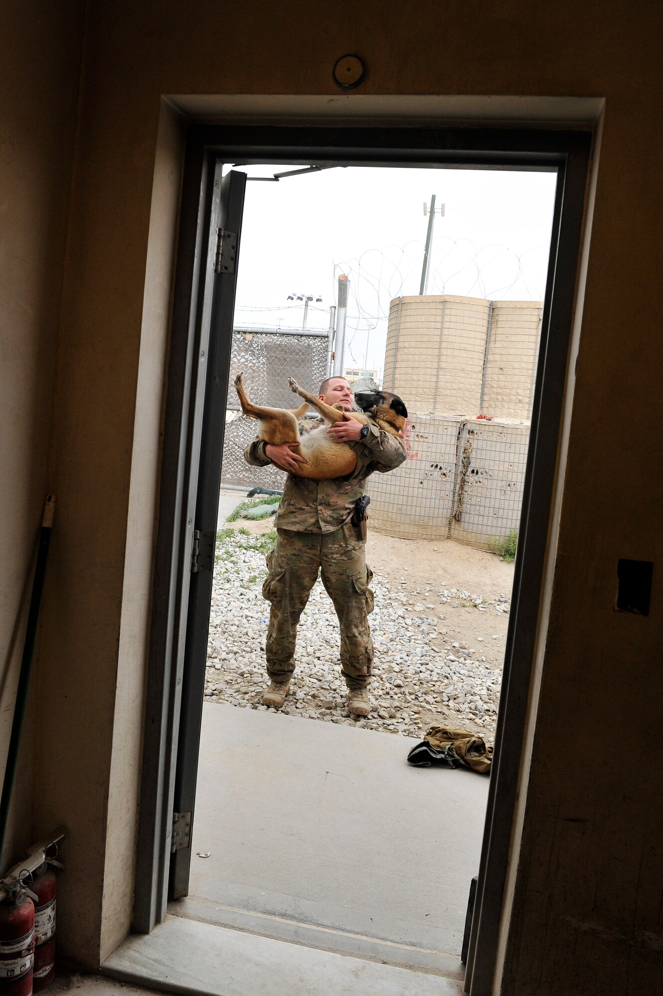 Staff Sgt. Jonathan Cooper, 455th Expeditionary Security Forces Group Military Working Dog handler, and his dog Astra take a break from their Vehicle-Borne Improvised Explosive patrol at Bagram Airfield, Afghanistan, April 29, 2013. Over the past four months, the MWD team has swept more than 15,000 vehicles, mitigating all VBIED threats to the installation.  (U.S. Air Force photo/Senior Airman Chris Willis)