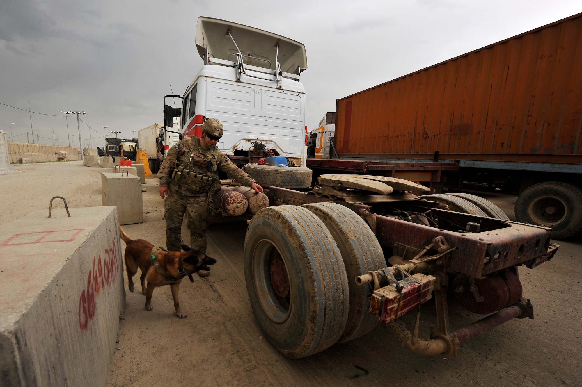 Staff Sgt. Jonathan Cooper, 455th Expeditionary Security Forces Group Military Working Dog handler, and his dog Astra search for Vehicle-Borne Improvised Explosive Devices at Bagram Airfield, Afghanistan, April 29, 2013. Vehicles come from all over Afghanistan and must be searched for VBIED threats before they can enter the installation. (U.S. Air Force photo/Senior Airman Chris Willis)