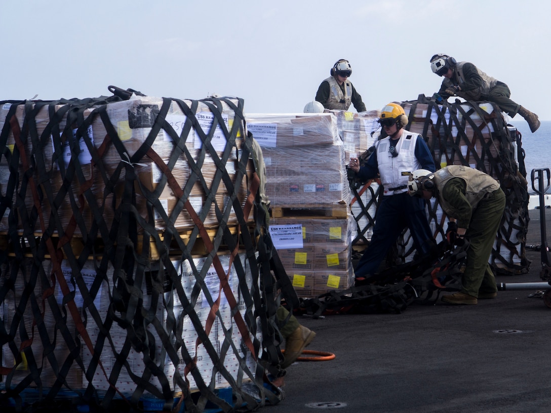 U.S. Combat Cargo Marines assigned to the 26th Marine Expeditionary Unit (MEU) and U.S. Sailors assigned to the USS Kearsarge (LHD 3), prepare to move supplies during a resupply at sea, on the flight deck of the Kearsarge, May 02, 2013. The 26th MEU is deployed to the 5th Fleet area of operations aboard the Kearsarge Amphibious Ready Group. The 26th MEU operates continuously across the globe, providing the president and unified combatant commanders with a forward-deployed, sea-based quick reaction force. The MEU is a Marine Air-Ground Task Force capable of conducting amphibious operations, crisis response and limited contingency operations.