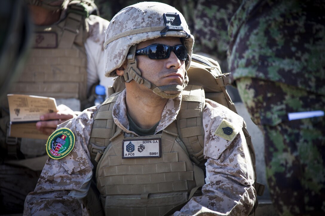 U.S. Marine Corps Staff Sgt. Gustavo Serpa of Paterson, N.J. with the Regional Corps Battle School (RCBS) listens to a safety brief being given to the Afghan National Army mortarmen at a mortar range near Camp Shorabak, Helmand province, Afghanistan, May 4, 2013. The Marines with RCBS trained the ANA soldiers to improve on their proficiency with the 60mm mortar weapons system. (U.S. Marine Corps photo by Staff Sgt. Ezekiel R. Kitandwe/Released)