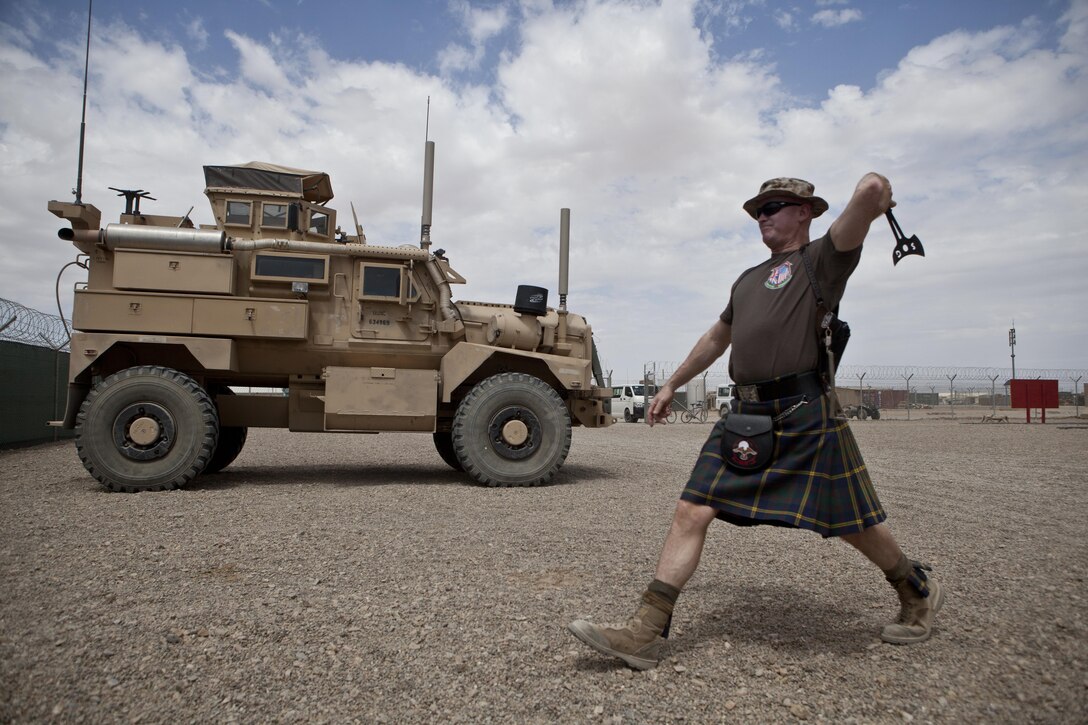 U.S. Marine Corps Col. Robert Curtis, fire and effects coordinator for Regional Command (Southwest), tosses an axe during the Highland Games at Camp Leatherneck, Afghanistan, May 3, 2013. A version of the Highland Games, an annual competition held in Scotland, was put on by the Marines and showcased a variety of athletic events. (U.S. Marine Corps Photo by Sgt. Tammy K. Hineline/Released)