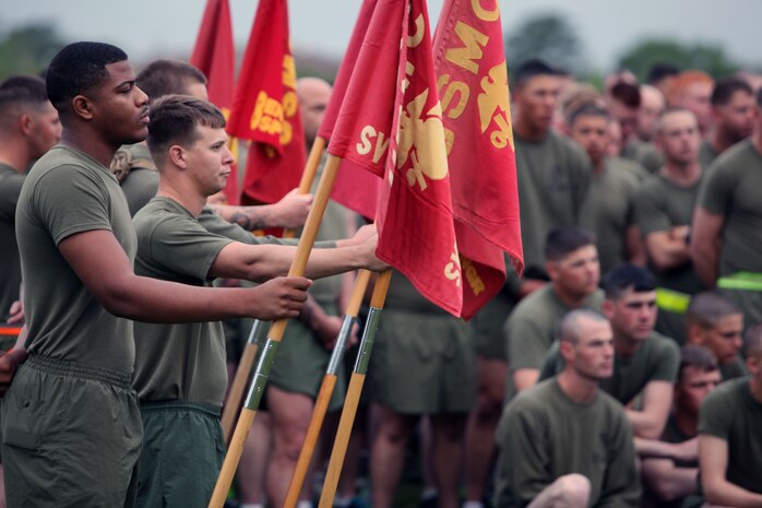 Marines with 2nd Marine Logistics Group hold their unit guidons as Brig. Gen. Edward D. Banta, the commanding general of 2nd MLG speaks to the servicemembers before a unit field meet aboard Camp Lejeune, N.C., May 1, 2013. The command staff of 2nd MLG spoke to the Marines and sailors about current events happening in the unit. 