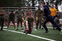 A Sailor with 2nd Marine Logistics Group kicks a football during a field goal challenge at the unit’s field meet aboard Camp Lejeune, N.C., May 1, 2013. Marines and sailors competed with each other in flag football, softball, soccer and volleyball throughout the day’s festivities