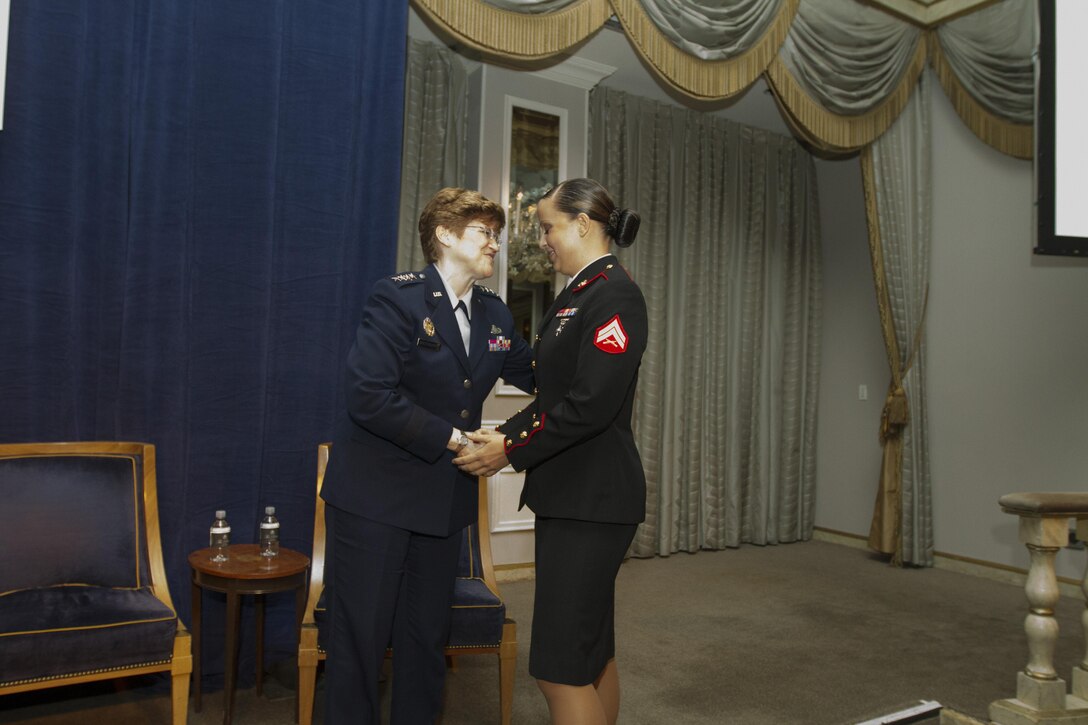 Cpl. MaryBeth Monson is congratulated for being awarded the Military Leadership Award by Air Force Gen. Janet C. Wolfenbarger, May 2, at The Pierre Hotel in New York, during the 2013 USO Woman of the Year Luncheon. Monson is an aircraft intermediate level structures mechanic with Marine Aviation Logistics Squadron 13, Marine Aircraft Group 13, 3rd Marine Aircraft Wing, I Marine Expeditionary Force. Wolfenbarger is the commander of Air Force Materiel Command and the USO Woman of the Year. (U.S. Marine Corps photo by Lance Cpl. Daniel E. Valle)