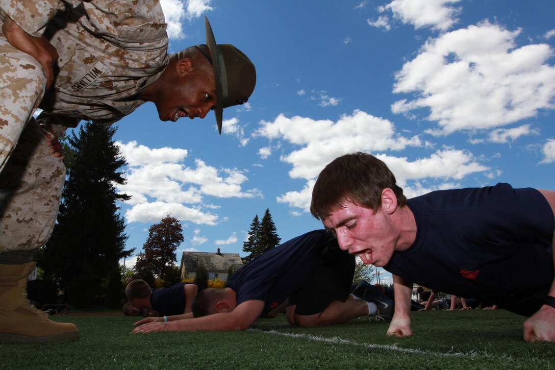 Sgt. Tashan Williams, a drill instructor from Marine Corps Recruit Depot, Parris Island, motivates Manson Bernardini, a 17-year-old Williamstown, Vt., native, during physical training as part of the 2013 Annual Field Meet, at Chicopee High School’s Football Field, May 4, 2013. Approximately 600 newly enlisted men and women from across New England, to include; Western Massachusetts, Connecticut, Vermont and Rhode Island, attended the event. The annual Marine Corps event is designed to test the Poolees’ physical fitness with a pull-up and sit-up competition to ensure that they are prepared for the rigors of Marine Corps boot camp. (Official Marine Corps Photo by Sgt. Richard Blumenstein) 