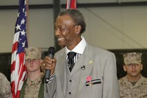 Former Pfc. Robert L. Rimpson talks to dozens of friends, family and spectators during an award ceremony where he was presented the Bronze Star Medal with Combat "V"  at the 24th Marine Regiment Drill Hall, May 4.