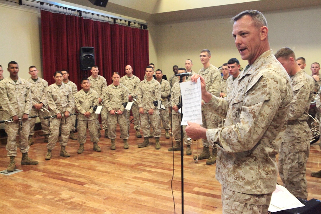 Chief Warrant Officer 2 Bryan Sherlock, Marine Corps Band New Orleans’ band officer, displays the original score of “Keep America Free,” by Amelie Prados Cressend, World War II veteran, just before performing the new, updated, rearranged and expanded version for her, her family and friends at Marine Corps Support Facility band hall, May 6th.  Retired Marine Corps musician, Former Staff Sgt. Jake Johnson, and Marine Corps Band New Orleans worked together  to bring Cressend’s dream and musical vision to life by harmonizing and rearranging her original score, and adapting the song into their official repertoire.