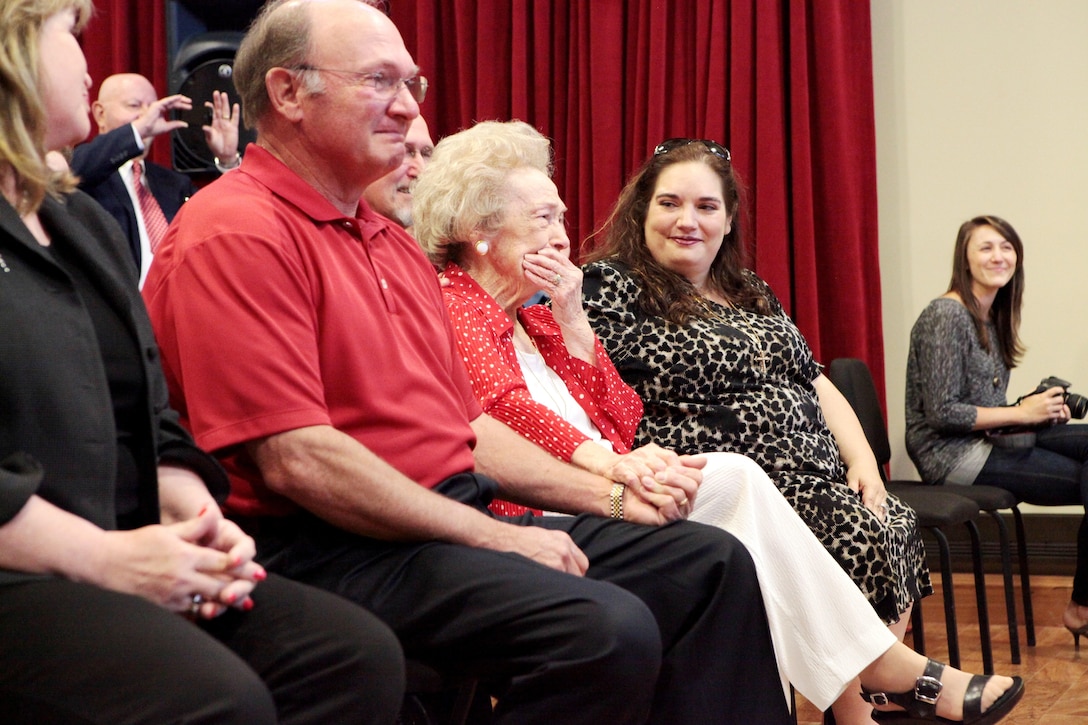 World War II veteran, Amelie Prados Cressend is moved to tears as Marine Corps Band New Orleans performs the rearranged, updated and expanded arrangement of her original song, “Keep America Free,” at Marine Corps Support Facility band hall, May 6. Retired Marine Corps musician, former Staff Sgt. Jake Johnson, and Marine Corps Band New Orleans worked together  to bring Cressend’s dream and musical vision to life by harmonizing and rearranging her original score, and adapting the song into their official repertoire.