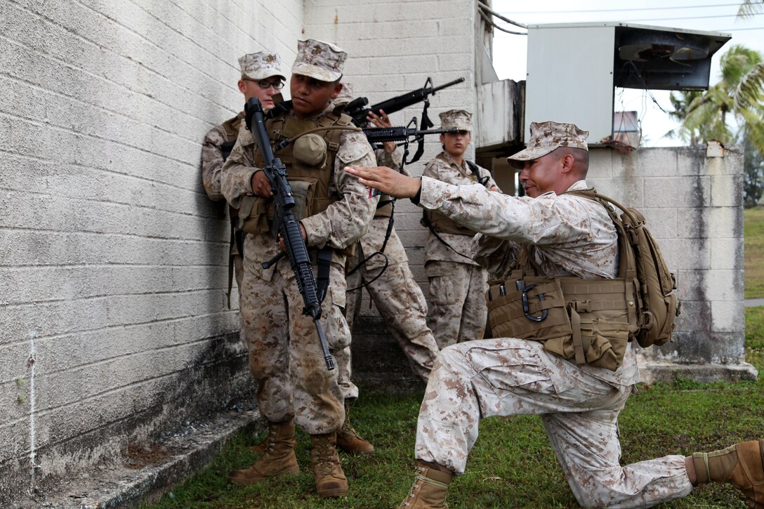 Gunnery Sgt. Brian D. Corpuz coaches his Marines during Military Operations in Urban Environments training April 25 while on a field operation during Exercise Guahan Shield.  Guahan Shield will facilitate multiservice engagement, set conditions for bilateral and multilateral training opportunities, and supported rapid response to potential theater crises and contingency operations in the Asia-Pacific region.  Corpuz is part of Combat Logistics Detachment 39, 9th Engineer Support Battalion, 3rd Marine Logistics Group, III Marine Expeditionary Force.  