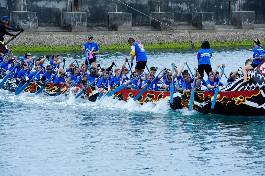 The Shogun Women's Dragon Boat Team paddles down the river during the Naha Dragon Boat Race in Naha City Port, Japan, May 5, 2013. This was the 39th annual dragon boat race, an Okinawan tradition, with both a women and men teams made up of active duty, civilians and family member volunteers. The dragon boat race is also a part of Golden Week, which is a collection of four different holidays within seven days for the community. (U.S. Air Force photo by Airman 1st Class Justin Veazie/Released)