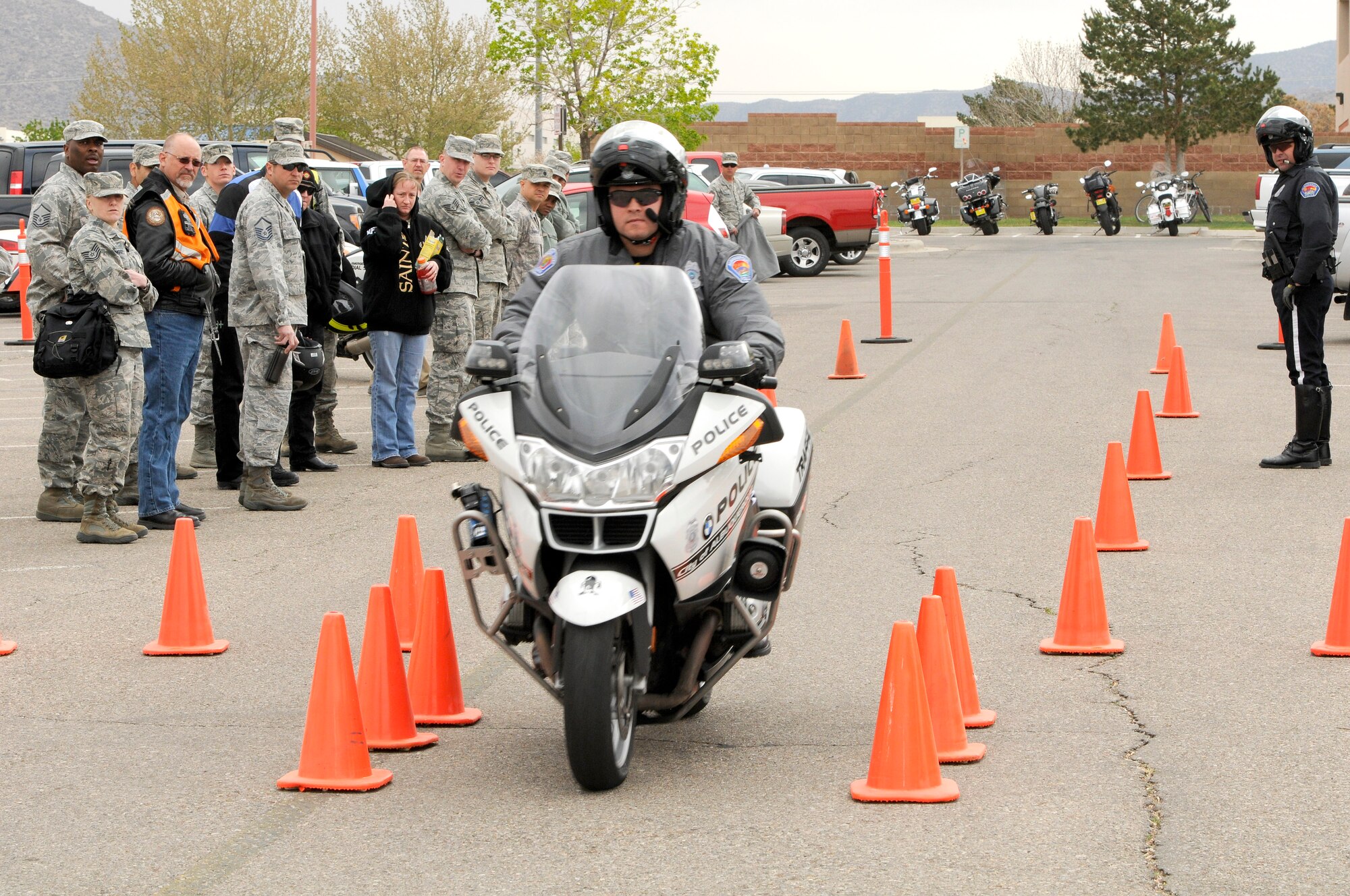 Officer Aaron Maldonado, Albuquerque Police Department, demonstrates the proper use of braking for onlookers during the Air Force Safety Center annual preseason motorcycle safety briefing held April 25 at the safety center. (U.S. Air Force photo by Keith A. Wright)