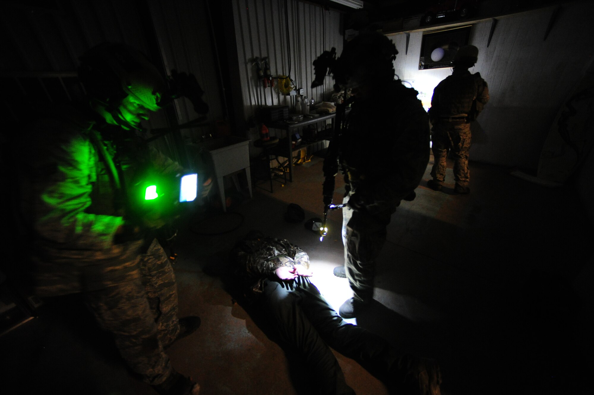 U.S. Air Force special operations security forces members use a secure electronic enrollment kit to identify an  opposing forces member during Emerald Warrior 2013, Apalachicola, Fla., April 29. The primary purpose of Emerald Warrior is to exercise special operations components in urban and irregular warfare settings to support combatant commanders. Emerald Warrior leverages lessons from Operation Iraqi Freedom, Operation Enduring Freedom and other historical lessons to provide better trained and ready forces to combatant commanders. (U.S. Air Force photo by Tech. Sgt. DeNoris A. Mickle)(Released)