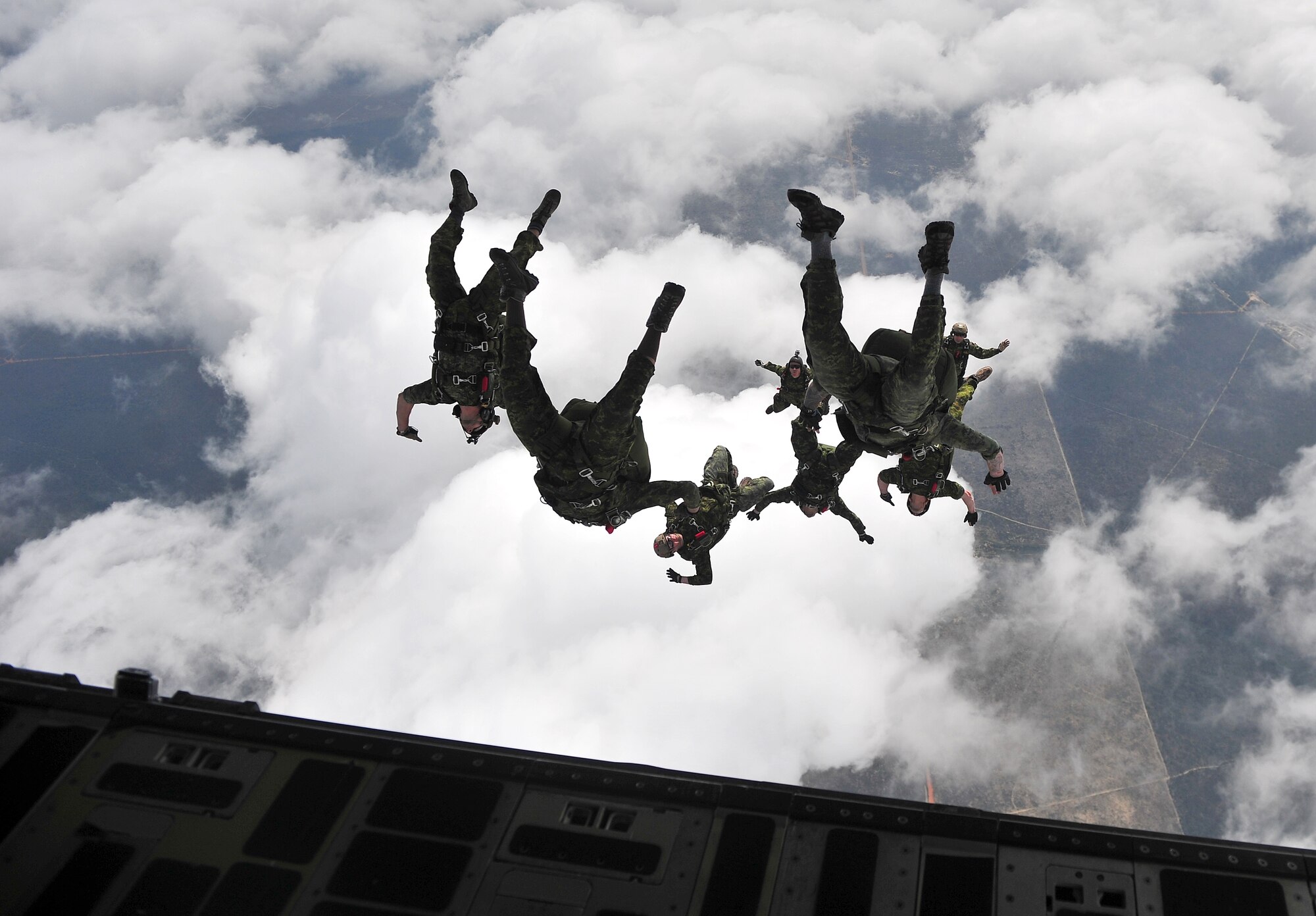 Canadian special operation regiment members conduct a freefall jump out of a U.S. Air Force C-17 Globemaster III during Emerald Warrior 2013, Hurlburt Field, Fla., April 28. The primary purpose of Emerald Warrior is to exercise special operations components in urban and irregular warfare settings to support combatant commanders. Emerald Warrior leverages lessons from Operation Iraqi Freedom,Operation Enduring Freedom and other historical lessons to provide better trained and ready forces to combatant commanders. (U.S. Air Force photo by Senior Airman Matthew Bruch)(Released)