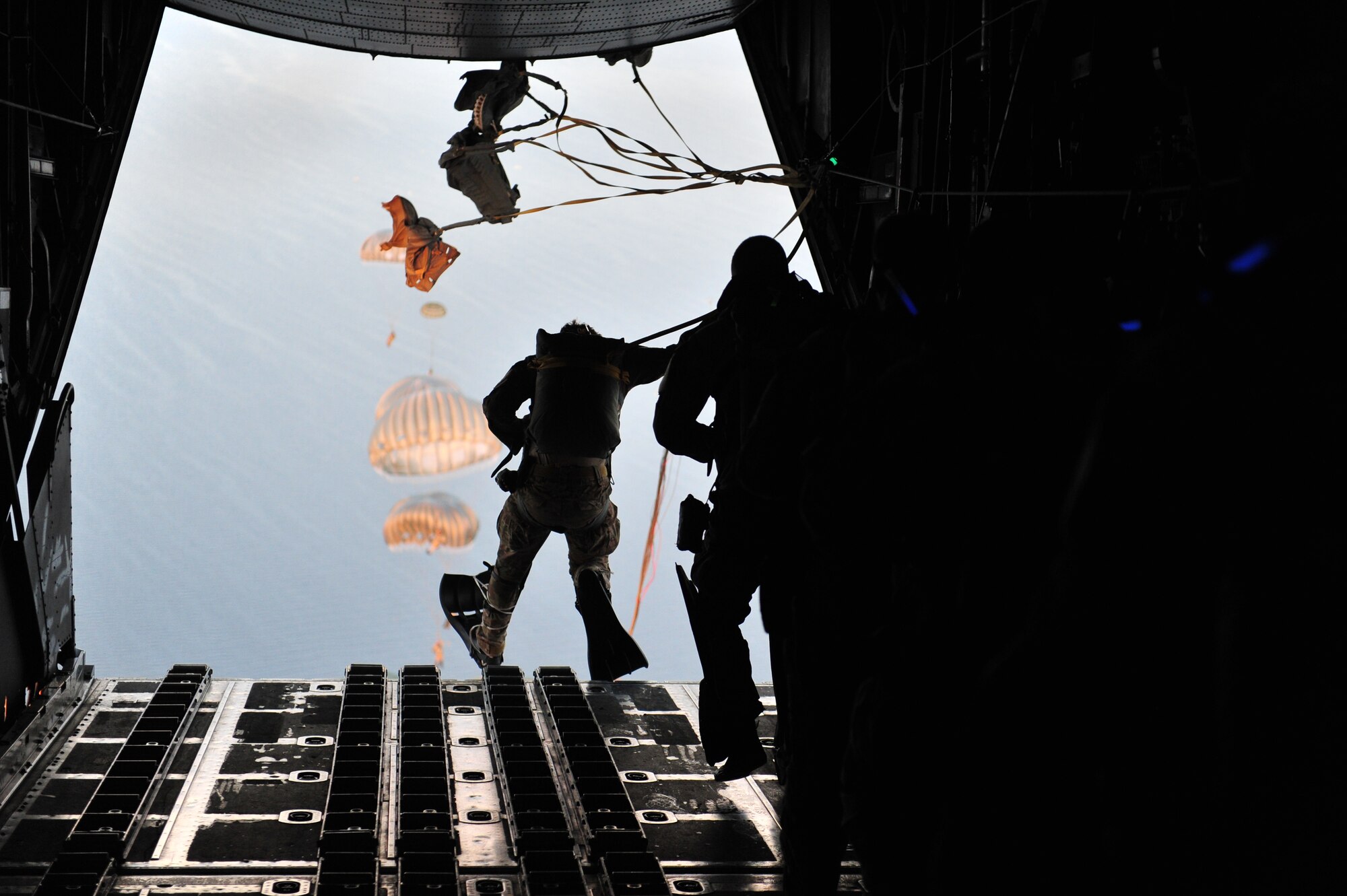 U.S. Air Force combat controllers and U.S. Army special forces execute a static line jump from a MC-130H Combat Talon II, during Emerald Warrior 2013, Hurlburt Field, Fla., April 26. The primary purpose of Emerald Warrior is to exercise special operations components in urban and irregular warfare settings to support combatant commanders. Emerald Warrior leverages lessons from Operation Iraqi Freedom,Operation Enduring Freedom and other historical lessons to provide better trained and ready forces to combatant commanders. (U.S. Air Force photo by Staff Sgt. Andy M. Kin)(Released)