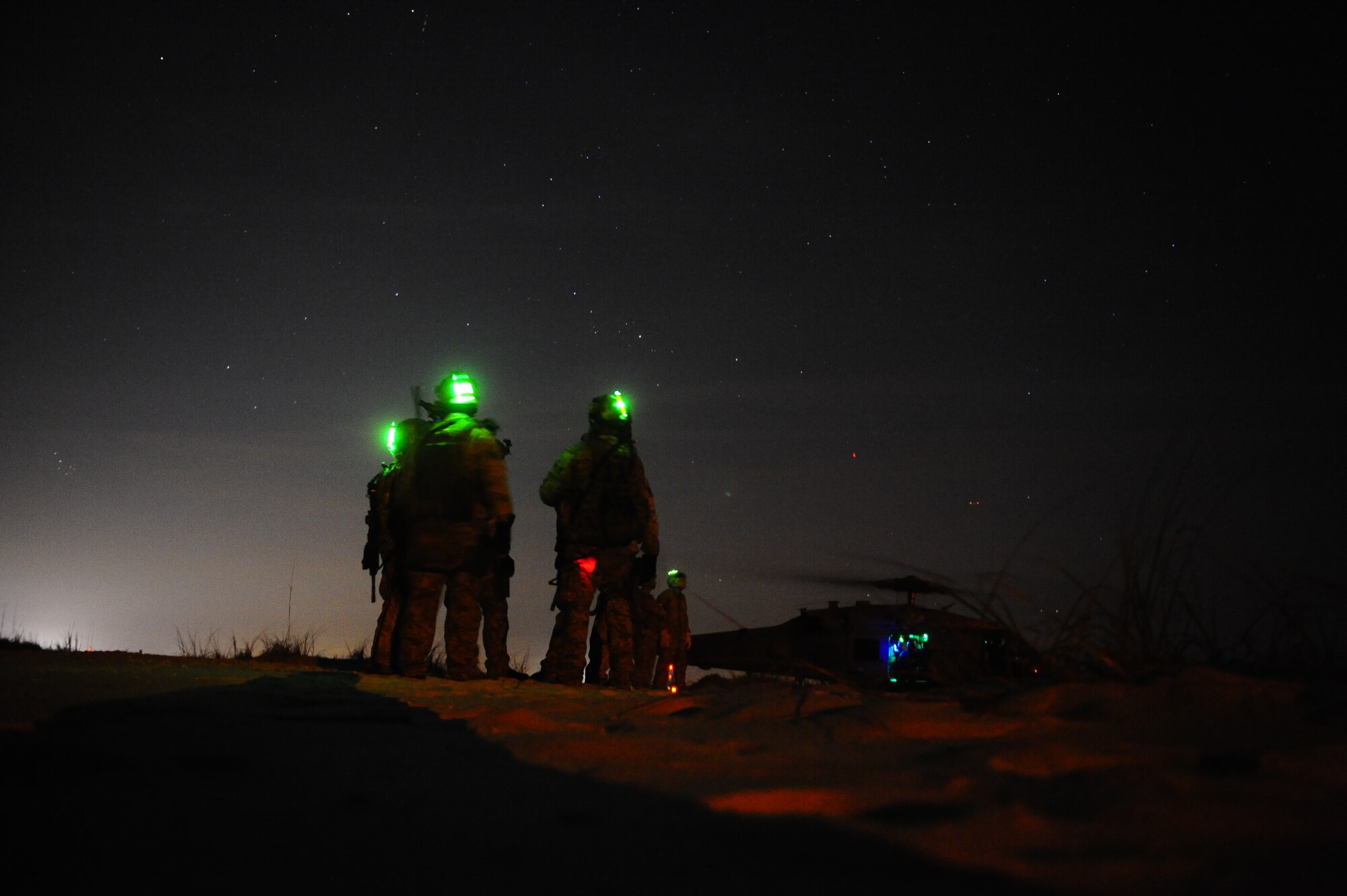 U.S. Air Force security forces members wait to board a U.S. Navy HH-60 Seahawk helicopter for fast rope training during Emerald Warrior 2013, Hurlburt Field, Fla., April 26. The primary purpose of Emerald Warrior is to exercise special operations components in urban and irregular warfare settings to support combatant commanders in theater campaigns. Emerald Warrior leverages lessons from Operation Iraqi Freedom,Operation Enduring Freedom and other historical lessons to provide better trained and ready forces to combatant commanders. (U.S. Air Force photo by Tech. Sgt. Quinton Russ)(Released)